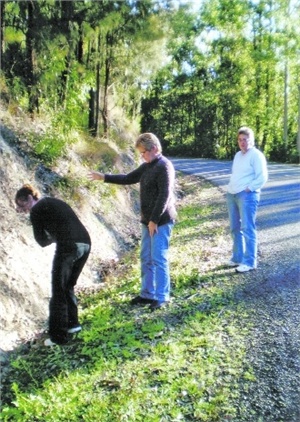 Faye Burke (centre), Alana Garrett (right) and a passer-by at the place where Fay and Alana saw what they believe was a yowie last Friday