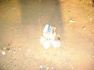 A stack of rocks with an empty water bottle<br />atop it was found in the jeep trail as we<br />travelled the forest in the wee hour